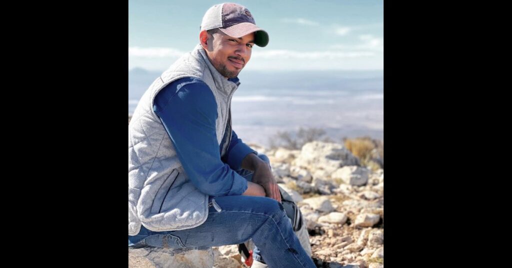 posing, smiling on top of highest peak in Texas Guadalupe mountains