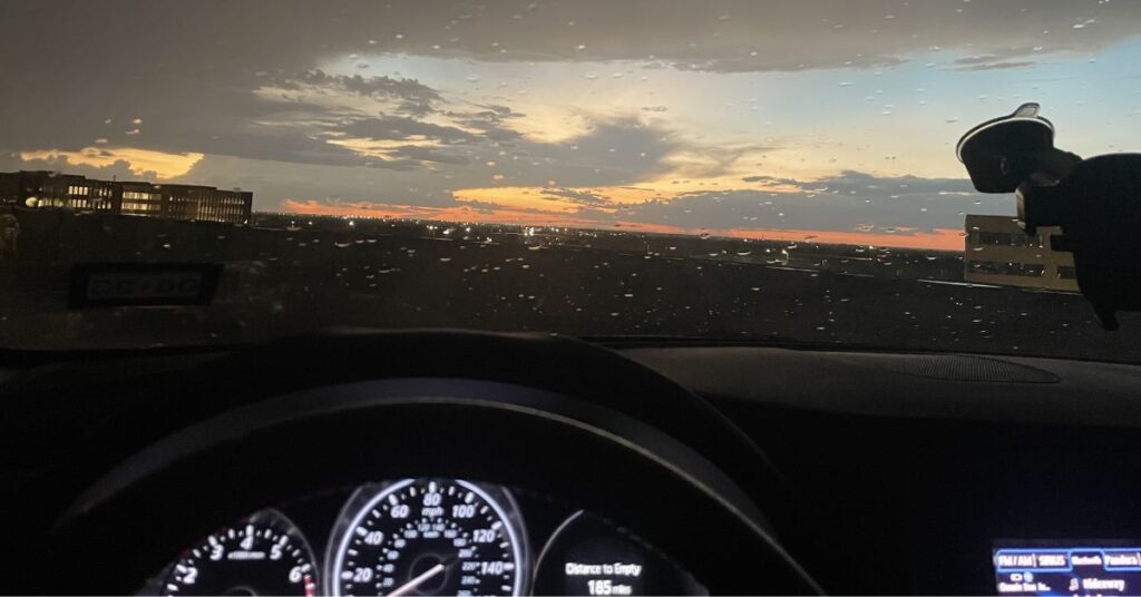 looking out windshield of car, sunset and rain