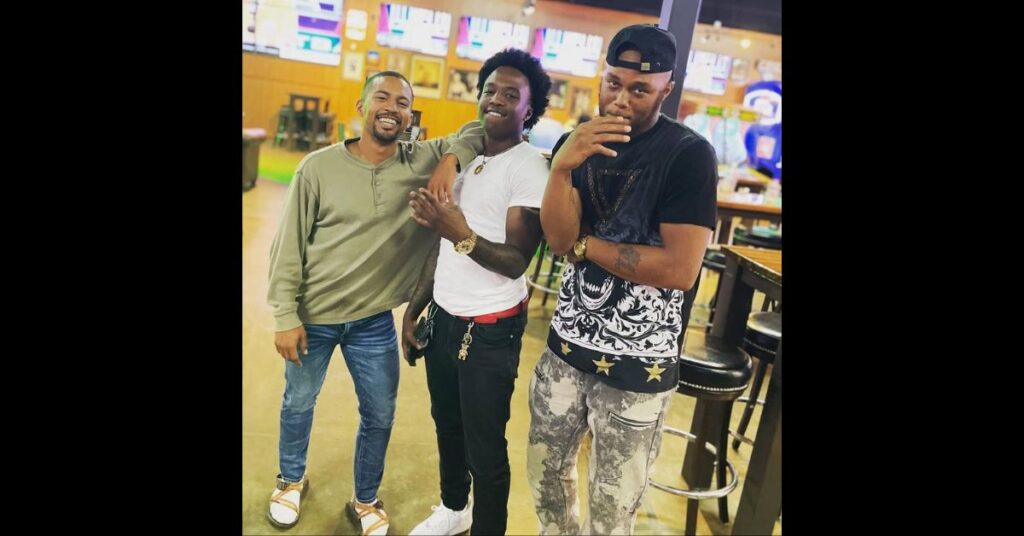 three friends posing at a bar