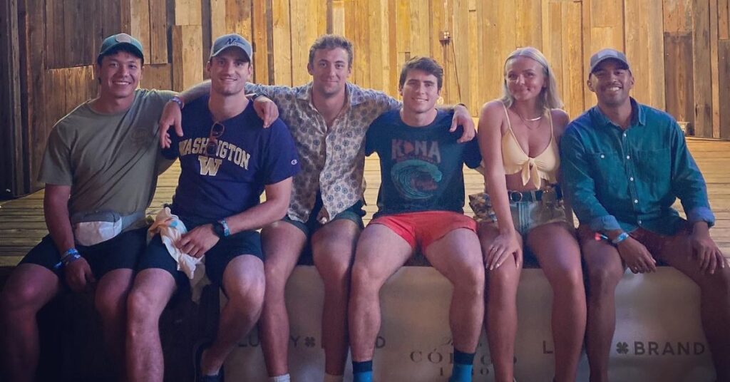 six friends sitting down and posing in Austin
