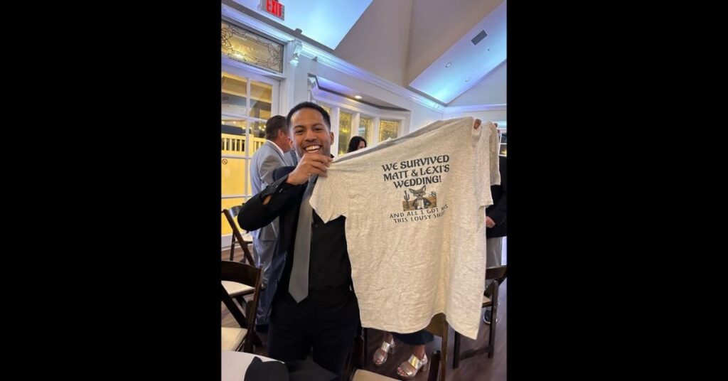 "I survived Matt and lexis wedding" shirt being held up