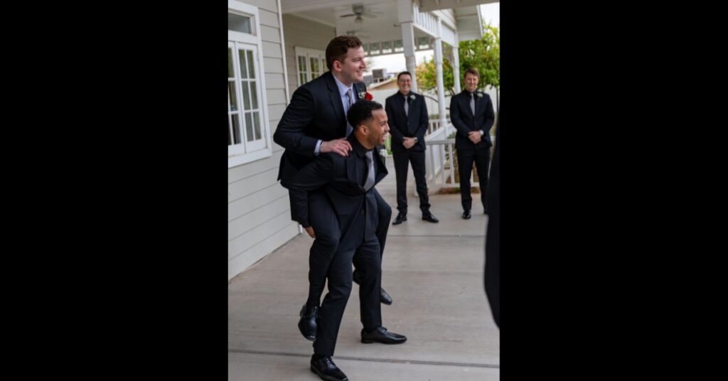 groom and groomsman piggyback fun