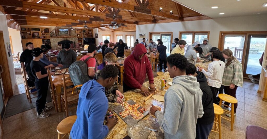 high school boys at church retreat preparing lunch