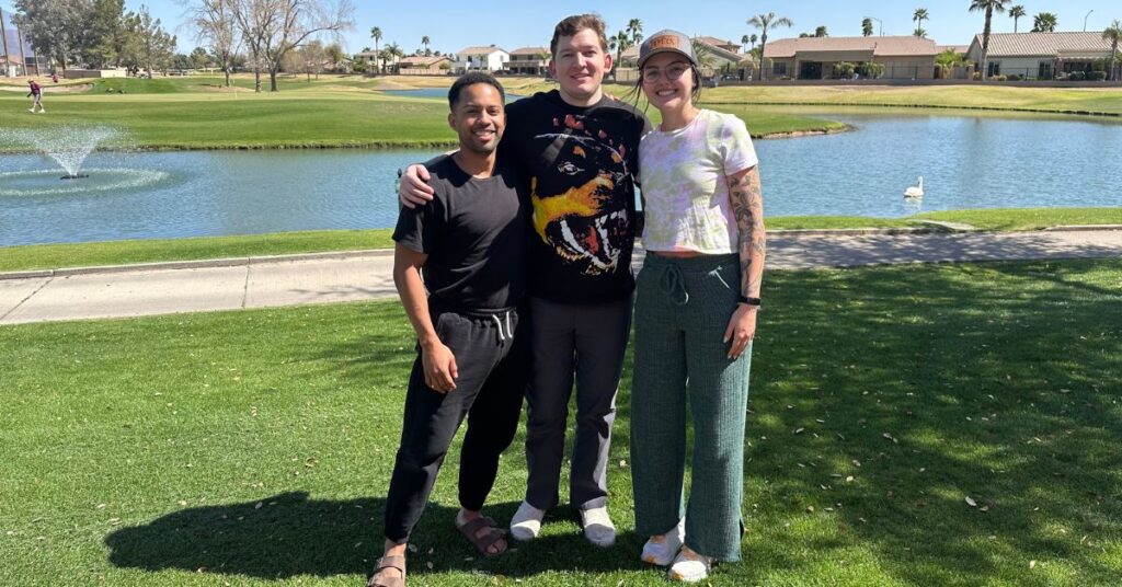 three friends with a duck pond backdrop
