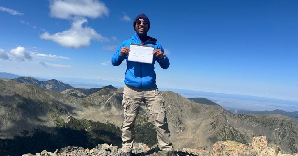 holding up a "13,000 feet" sign