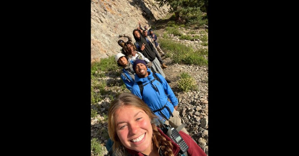 wilderness trek selfie on side of mountain