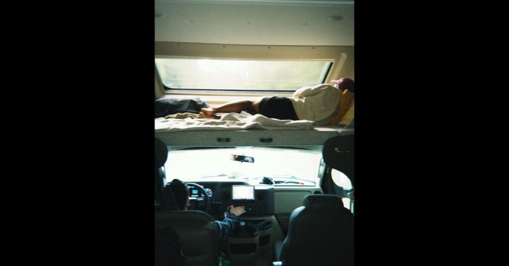 sleeping in the rv top rack above the driver