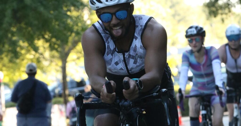 ironman 2025 Chattanooga biking and tongue out